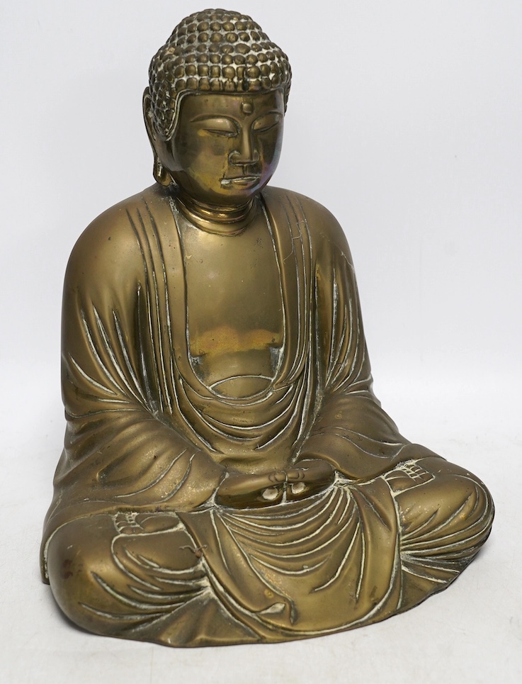 A cast brass figure of Buddha, 27cm high. Condition - fair to good